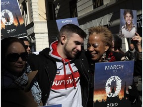 Sex abuse survivor Alessandro Battaglia is hugged by survivor and founding member of the ECA (Ending Clergy Abuse), Denise Buchanan, right, during a march in Rome, Saturday, Feb. 23, 2019. Pope Francis is hosting a four-day summit on preventing clergy sexual abuse, a high-stakes meeting designed to impress on Catholic bishops around the world that the problem is global and that there are consequences if they cover it up.