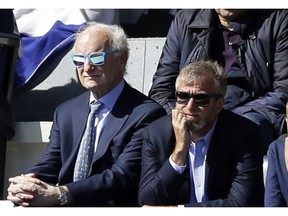 FILE - In this Sunday, April 12, 2015 file photo, Chelsea's Russian owner Roman Abramovich, right, and Chelsea chairman Bruce Buck, left, watch during the second half of the English Premier League soccer match between QPR and Chelsea at Loftus Road stadium in London. Gathered with his Chelsea's directors, Roman Abramovich stopped the football talk to raise deep concerns he wanted them to address at the club and beyond.