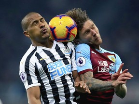 Newcastle United's Salomon Rondon, left and Burnley's Jeff Hendrick battle for the ball in the air, during the English Premier League soccer match between Newcastle and Burnley, at St James' Park, in Newcastle, England, Tuesday, Feb. 26, 2019.