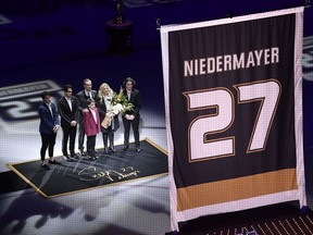 Former Anaheim Ducks defenseman Scott Niedermayer watches along with his family as his jersey is retired prior to an NHL hockey game between the Ducks and the Washington Capitals Sunday, Feb. 17, 2019, in Anaheim, Calif.