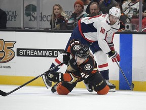 Anaheim Ducks defenseman Michael Del Zotto, below passes the puck while under pressure from Washington Capitals right wing Brett Connolly during the first period of an NHL hockey game Sunday, Feb. 17, 2019, in Anaheim, Calif.