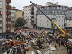 Rescue workers continue to remove rubble from an eight-story building which collapsed two days earlier in Istanbul, Friday, Feb. 8, 2019. Turkish rescue workers on Friday pulled out a 16-year-old boy from the rubble of an eight-story apartment building in Istanbul two days after it collapsed, Turkey's interior minister Suleyman Soylu said.