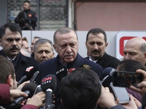 Turkey's President Recep Tayyip Erdogan speaks to the media as he visits the site of a collapsed building in Istanbul, Saturday, Feb. 9, 2019. Erdogan says there are "many lessons to learn" from the collapse of a residential building in Istanbul where at least 17 people have died. (Presidential Press Service via AP, Pool)