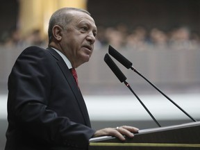 Turkey's President Recep Tayyip Erdogan addresses the MPs of his ruling Justice and Development Party at the parliament, in Ankara, Turkey, Tuesday, Feb. 5, 2019. (Presidential Press Service via AP, Pool)