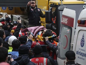 Rescue workers carry 5-year old girl Havva Tekgoz, after she was pulled from the rubble of an eight-storey building, some 18-hours after it collapsed, in Istanbul, Turkey, Thursday, Feb. 7, 2019. The girl, Havva Tekgoz, was seen on Thursday being carried by stretcher to a waiting ambulance, as one person in a crowd of onlookers chanted: "God is great!."   Istanbul Gov. Ali Yerlikaya told reporters early Thursday that rescue teams working overnight pulled 12 people out of the rubble with injuries and at least three people are confirmed dead.
