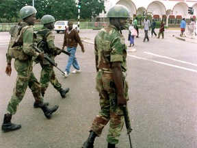 Zimbabwean national Army details patrol the streets of Harare's high density suburb of Highfields January 21. A husband and wife from Zimbabwe who were found complicit in crimes against humanity for their years working together in the Zimbabwe National Army have lost their dogged appeals to avoid deportation from Canada.