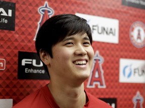 Los Angeles Angels' Shohei Ohtani talks to the media at their spring baseball training facility in Tempe, Ariz., Wednesday, Feb. 13, 2019. The AL Rookie of the Year is recovering from Tommy John surgery.