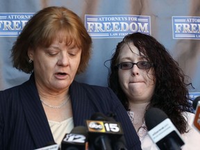Anya Chapman, right, listens as attorney Jody Broaddus reads Chapman's statement to the media concerning Chapman's husband, Johnny Wheatcroft, Monday, Feb. 11, 2019, in Chandler, Ariz. Broaddus has filed a lawsuit on behalf of Wheatcroft claiming the Glendale, Ariz. police dept. used excessive force against Wheatcroft during his arrest in 2017.