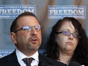 Attorney Marc J. Victor speaks to the media concerning his client, Johnny Wheatcroft, Monday, Feb. 11, 2019, in Chandler, Ariz. as Wheatcroft's wife, Anya Chapman, right, listens. Victor has filed a lawsuit on behalf of Wheatcroft claiming the Glendale, Ariz. police dept. used excessive force against Wheatcroft during his arrest in 2017.