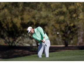 Defending champion Gary Woodland hits from the second fairway during the second round of the Phoenix Open PGA golf tournament, Friday, Feb. 1, 2019, in Scottsdale, Ariz.
