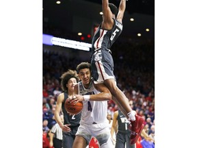 Arizona center Chase Jeter (4) is fouled by Washington State forward Marvin Cannon during the second half during an NCAA college basketball game Saturday, Feb. 9, 2019, in Tucson, Ariz. Washington State defeated Arizona 69-55.