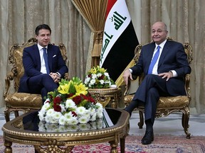 Iraqi President Barham Salih, right, meets with visiting Italian Prime Minister Giuseppe Conte in Baghdad, Iraq, Wednesday, Feb. 6, 2019.