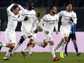 AC Milan's Hakan Calhanoglu, 2nd right, celebrates after scoring during the Serie A soccer match between Atlanta and AC Milan at the Azzurrid'Italia Stadium in Bergamo, Italy, Saturday, Feb. 16, 2019.