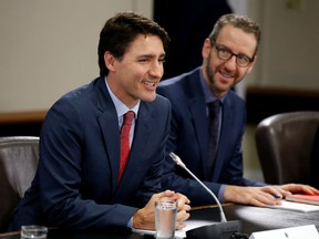 Canada's Prime Minister Justin Trudeau (L) and his principal secretary Gerald Butts take part in a meeting with Italy's Prime Minister Paolo Gentiloni (not pictured) on Parliament Hill in Ottawa, Ontario, Canada, April 21, 2017.