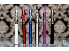 FILE - In this April 23, 2014 file photo, E-cigarettes appear on display at Vape store in Chicago. The Vermont House is expected to give final approval on Friday, Feb. 1, 2019 to a proposal to tax on e-cigarettes.