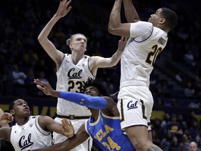California's Matt Bradley, right, reaches for a rebound with Connor Vanover (23) over UCLA's Jalen Hill (24) during the first half of an NCAA college basketball game Wednesday, Feb. 13, 2019, in Berkeley, Calif.