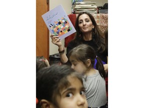 In this Jan. 23, 2019, photo, Bahareh Hedyahe leads Persian story time at Irvine public library in Irvine, Calif. It's been four decades since the Iranian revolution overthrew the ruling shah, prompting tens of thousands of Iranian exiles and refugees to make their lives in the United States. Years later, they have set down roots here and are finding ways to pass their love of Iranian culture to their American children and grandchildren.