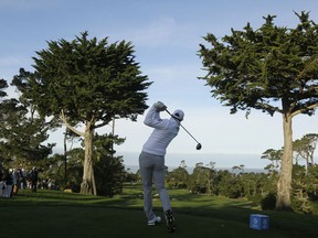 Dustin Johnson hits from the first tee of the Monterey Peninsula Country Club Shore Course during the first round of the AT&T Pebble Beach National Pro-Am golf tournament Thursday, Feb. 7, 2019, in Pebble Beach, Calif.