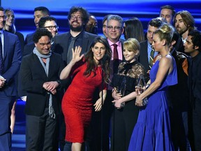 FILE - In this Jan. 18, 2017 file photo, the cast and crew of "The Big Bang Theory" accept the award for favorite network TV comedy at the People's Choice Awards at the Microsoft Theater in Los Angeles. Champagne is briefly replacing scripts on the set of "The Big Bang Theory." A nondescript building on the sprawling Warner Brothers production lot in Burbank known as Stage 25 was renamed Thursday, Feb. 7, 2019, for the CBS sitcom that called it home for 12 years and will soon depart.