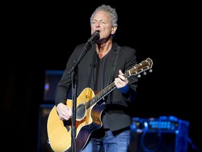 FILE - In this Dec. 5, 2018 file photo, Lindsey Buckingham performs at The Wilbur Theatre in Boston. Buckingham underwent open heart surgery that left the former Fleetwood Mac guitarist with damaged vocal cords. Buckingham's publicist said in a statement Friday, Feb. 8, 2019, that he experienced chest pains last week and was taken to the hospital where he had the life-saving procedure. He is recovering at home with his family.