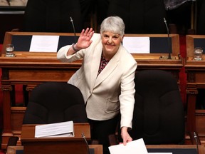 Finance Minister Carole James arrives to deliver the budget speech as she waves to people in the gallery at the legislature in Victoria, B.C., on Tuesday, February 19, 2018.