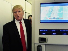 FILE - In this Sunday, Feb. 3, 2019 file photo, President Donald Trump speaks to reporters onboard Air Force One, on his way back to the White House in Washington from a weekend at his Mar-a-Lago estate in Palm Beach, Fla. Iraq's President Barham Salih spoke Monday at a forum in Baghdad slamming comments by Trump in which he said he wants to keep U.S. troops in Iraq "to watch Iran." Salih said the U.S. president did not ask Iraq's permission for American troops stationed there to watch Iran. He said the Iraqi constitution forbids the use of Iraq as a base to threaten the interests or security of neighboring countries.