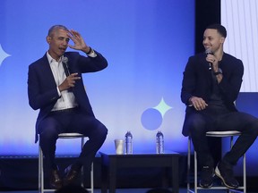 Former President Barack Obama, left, gestures as Golden State Warriors basketball player Stephen Curry laughs while speaking at the My Brother's Keeper Alliance Summit in Oakland, Calif., Tuesday, Feb. 19, 2019.