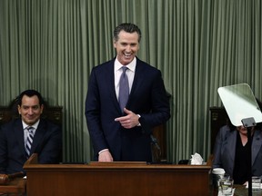 California Gov. Gavin Newsom delivers his first state of the state address to a joint session of the legislature at the Capitol Tuesday, Feb. 12, 2019, in Sacramento, Calif. Newsom was flanked by Assembly Speaker Anthony Rendon, D-Lakewood, left, and Senate President Pro Tem Toni Atkins, D-San Diego.