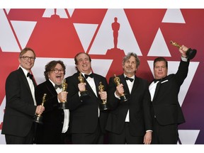 Jim Burke, from left, Charles B. Wessler, Nick Vallelonga, Peter Farrelly, and Brian Currie pose with the award for best picture for "Green Book" in the press room at the Oscars on Sunday, Feb. 24, 2019, at the Dolby Theatre in Los Angeles.
