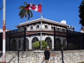 A man walks beside Canada's embassy in Havana, Cuba, Tuesday, April 17, 2018.