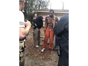 FILE - This Feb. 3, 2019 photo released by the Conroe Police Department shows Cedric Marks being captured after nine-hour manhunt that began when he escaped from a prisoner transport van in Conroe, Texas. A private prisoner transport company has told Texas officials it is shutting down after an MMA fighter accused of two murders escaped from its van last week. (Conroe Police Department via AP)
