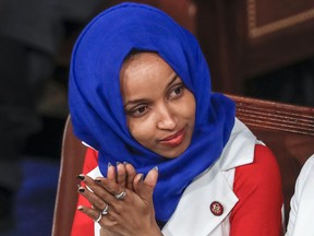 FILE - In this Feb. 5, 2019, file photo, Rep. Ilhan Omar, D-Minn., listens to President Donald Trump's State of the Union speech, at the Capitol in Washington. Omar "unequivocally" apologized Monday, Feb. 11, 2019, for tweets suggesting that members of Congress support Israel because they are being paid to do so, which drew bipartisan criticism and a rebuke from House Speaker Nancy Pelosi.