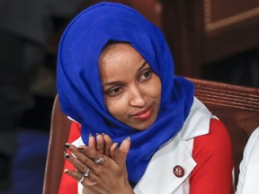 In this Feb. 5, 2019, file photo, Rep. Ilhan Omar, D-Minn., listens to President Donald Trump's State of the Union speech, at the Capitol in Washington.