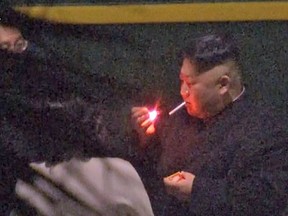 Kim Jong-un, a habitual smoker, takes a pre-dawn smoke break Tuesday at a train station in China hours before his arrival in Vietnam for his high-stakes summit with President Donald Trump.