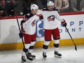 Columbus Blue Jackets right wing Oliver Bjorkstrand, right, celebrates his goal with defenseman Markus Nutivaara during the first period of an NHL hockey game against the Colorado Avalanche on Tuesday, Feb. 5, 2019, in Denver.