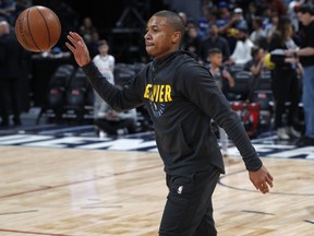 FILE - In this Monday, Fb. 11, 2019, file photo, Denver Nuggets guard Isaiah Thomas warms up before an NBA basketball game against the Miami Heat in Denver. Thomas, who has been sidelined since last season, may take the court Wednesday, Feb. 13, for the first time in a Nuggets uniform.