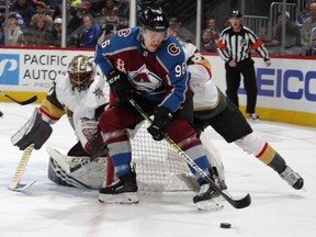 Colorado Avalanche right wing Mikko Rantanen, front, wraps around the net past Vegas Golden Knights defenseman Nate Schmidt to put a shot on goaltender Malcolm Subban in the first period of an NHL hockey game Monday, Feb. 18, 2019, in Denver.
