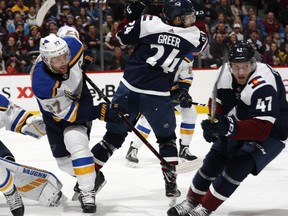 St. Louis Blues defenseman Alex Pietrangelo, left, clears the puck form in front of the crease and past Colorado Avalanche left wing A.J. Greer and center Dominic Toninato, right, in the first period of an NHL hockey game Saturday, Feb. 16, 2019, in Denver.
