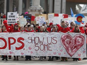 Instructors march to Denver Public Schools headquarters to deliver Valentine Day cards Wednesday, Feb. 13, 2019, in Denver. Teachers walked off their jobs Monday, the first strike by teachers in Denver in 25 years.
