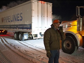 Ken Husband, a trucker from Strathmore, Alta., unwinds after arriving with the convoy at a meeting point outside of Regina.