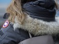 In this Feb. 14, 2019 photo, a woman in New York wears a Canada Goose coat with a hood fur trimmed with coyote fur.