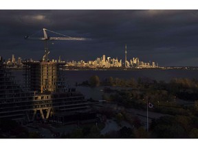 Condominiums are seen under construction in front of the skyline in Toronto, Ont., on Tuesday October 31, 2017. Home sales in Toronto and the surrounding area saw a small uptick in January, a sign that the real estate market in Canada's largest city remains stable.