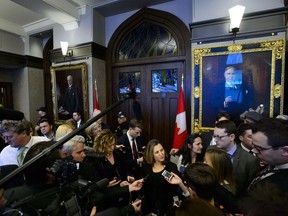Minister of Foreign Affairs Chrystia Freeland talks to media as she makes here way through the foyer of the House of Commons in the West Block of Parliament Hill as she arrives for question period in Ottawa on Monday, Jan. 28, 2019. Canada and Britain will co-host an international summit in London this summer on the growing threats to freedom of the press, and to promote better protection of journalists,