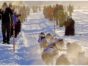 A haze hangs around spectators on the Chena River as teams left Fairbanks, Alaska, during the start of the Yukon Quest sled dog race Saturday, Feb. 3, 2018. An event considered to be the toughest dog sled race on the planet begins Saturday in Whitehorse.