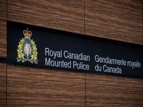 The RCMP logo is seen outside Royal Canadian Mounted Police "E" Division Headquarters, in Surrey, B.C., on Friday April 13, 2018. The Royal Canadian Mounted Police have charged a second public official with breach of trust in connection with the alleged leak of cabinet secrets around a $700-million naval shipbuilding contract.