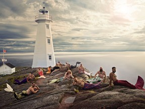 Men from the Newfoundland and Labrador Beard and Moustache Club pose as mermaids at Cape Spear Lighthouse National Historic site in this undated handout photo. What started as a dare for a burly Newfoundland man to pose in mermaid flippers has turned into a globally known effort to combat gender stereotypes, and raised more than a half million dollars for charity.