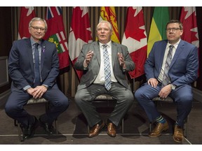 Ontario Premier Doug Ford, centre, speaks to reporters as Saskatchewan Premier Scott Moe, right, and New Brunswick Premier Blaine Higgs look on during a meeting of Canada's premiers in Montreal, Thursday, December 6, 2018. Three of Canada's premiers are in Washington to press the Trump administration for an end to punishing U.S. tariffs on steel and aluminum imports from north of the border.