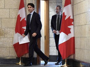 Prime Minister Justin Trudeau leaves his office with his principal secretary Gerald Butts to attend an emergency cabinet meeting on Parliament Hill in Ottawa on Tuesday, April 10, 2018. Butts has resigned amid allegations that the Prime Minister's Office interfered to prevent criminal prosecution of SNC-Lavalin.