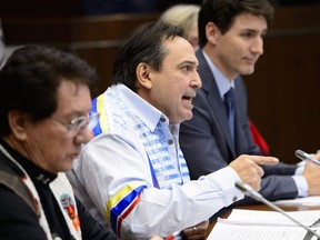 Assembly of First Nations National Chief Perry Bellegarde speaks alongside Akwesasne Elder Mike Mitchell, left, and Prime Minister Justin Trudeau during a meeting with Assembly of First Nations leaders in Ottawa on Monday, Jan. 14, 2019. The Trudeau Liberals are poised to introduce a promised new law to protect and promote Indigenous languages.