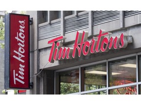 A Tim Horton logo is pictured Tuesday, June 21, 2016 in Montreal. Tim Hortons and an association representing some of its frustrated franchisees are close to reaching a settlement in two class action lawsuits the group filed against the coffee chain.